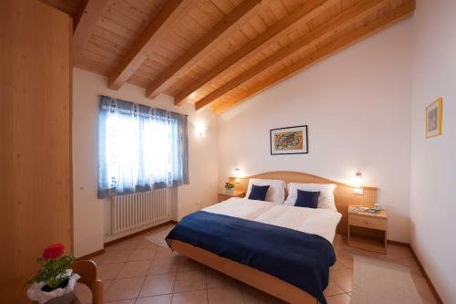 a bedroom with a large bed and a window at Appartamento Ai Ruck in Limone sul Garda