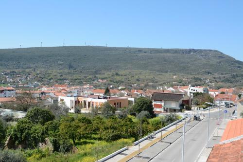 a view of a town with a mountain in the background at Residencial o Bras in Alvaiázere