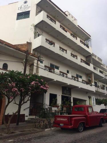 a red truck parked in front of a building at Casa del Parque Vallarta in Puerto Vallarta