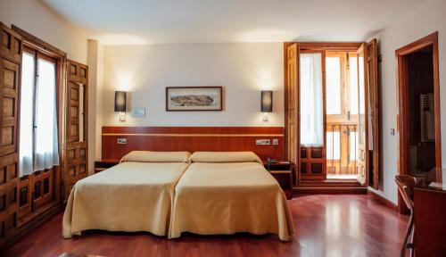 a bedroom with a large bed in a room at Hotel Santa Isabel in Toledo
