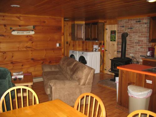 a living room with a couch and a stove at Okie Dokie Cabins in Tamworth