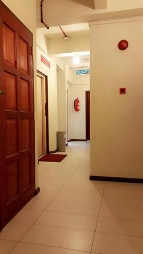 a hallway of an office with a door and a hallwayngthngthngthngthngth at City Inn in Kuching
