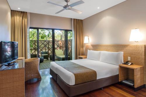 a hotel room with a bed and a television at Kimberley Sands Resort in Broome