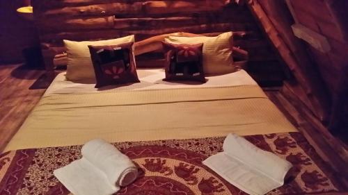 a bed in a room with pillows on it at Lizard Safari Lodge in Udawalawe