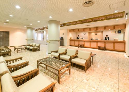 a lobby with a waiting area with chairs and tables at Koriyama Washington Hotel in Koriyama