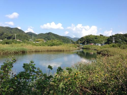 a river with trees and mountains in the background at Retreat wabi-sabi - walk to Ohama Beach - Max 12 ppl in Shimoda