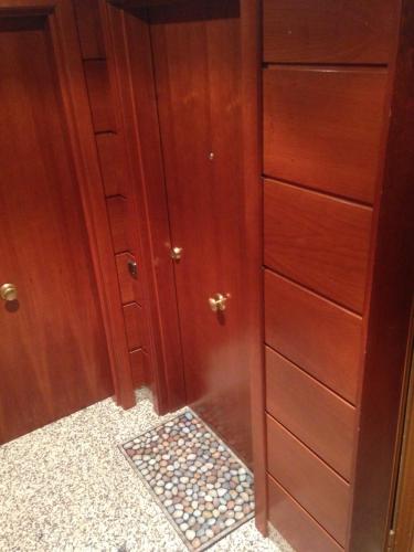 a wooden closet with a door and a mosaic floor at Apartaments Vicus 1 con vistas a la Plaza Mayor de Vic in Vic