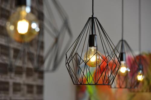 a hanging light fixture with a bottle in it at SleepySleepy Hotel Gießen in Gießen