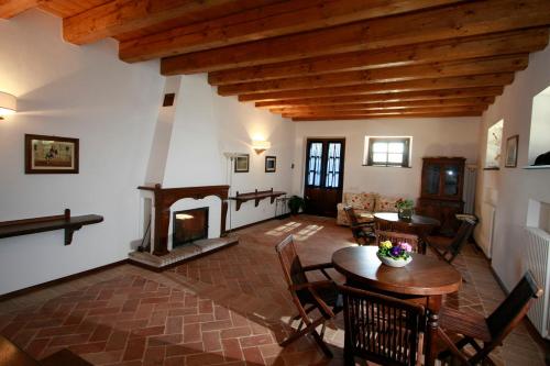 a living room with a table and a fireplace at Rustico del Conero in Camerano
