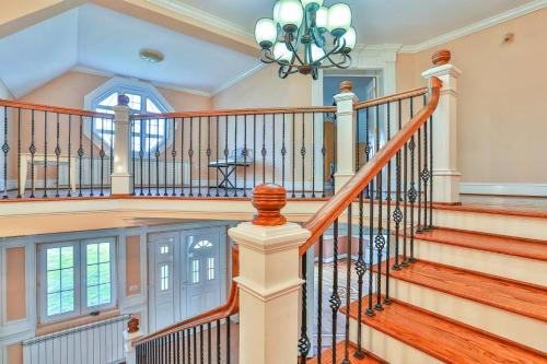 a large staircase in a home with a chandelier at Casa Iulia in Haţeg