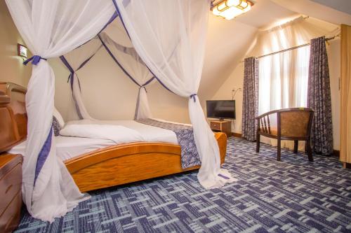 a bedroom with a bed with a canopy at Wida Resort Kilimani in Nairobi