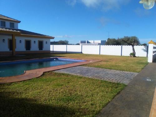 a swimming pool in the yard of a house at Casa Rural Viña Chica in Dos Hermanas