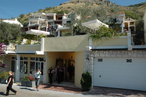 a group of people standing outside of a building at Apartments Balic in Sveti Stefan