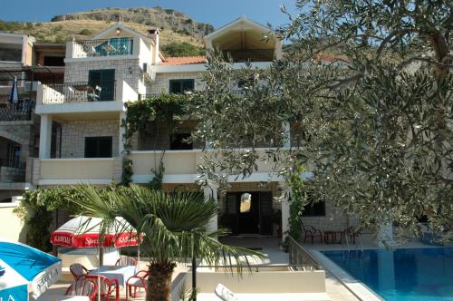 a view of the hotel from the pool at Apartments Balic in Sveti Stefan