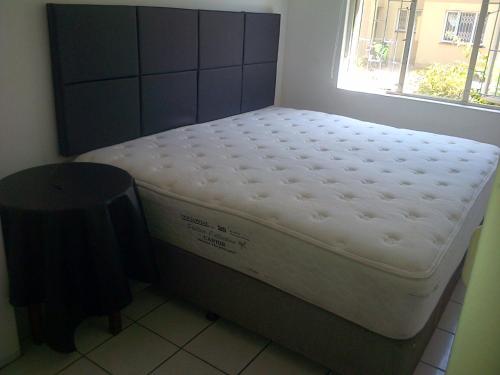 a mattress sitting in a room with a window at Durban Accommodation 118 Summersands in Durban