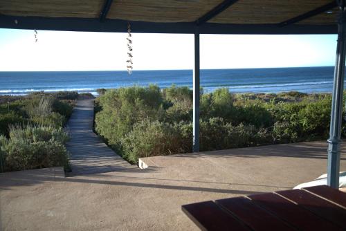 a porch with a view of the beach at 3 Dolphins in Britannia Bay