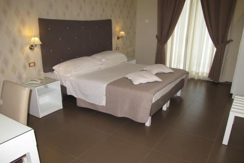 Postel nebo postele na pokoji v ubytování Hotel Club