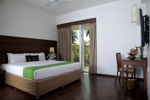Кровать или кровати в номере Temple Tree Hotel