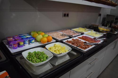 a buffet with many different types of food on at Hotel H2 Avila in Avila