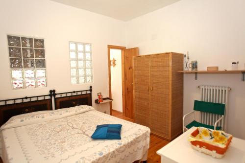 a bedroom with a bed and a table and a cabinet at Casa Manu Apartments in Monterosso al Mare