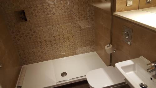 a bathroom with a shower and a toilet and a sink at The Bull & Stirrup Hotel Wetherspoon in Chester