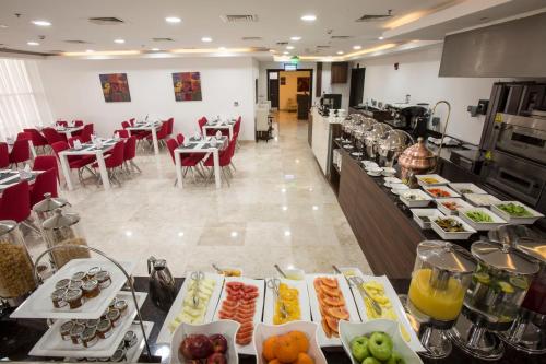 a buffet line with many different types of food at The Town Hotel Doha in Doha