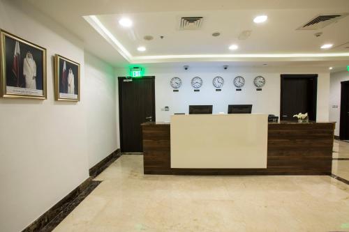 a waiting room with a counter and plates on the wall at The Town Hotel Doha in Doha