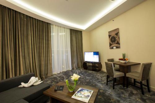 a living room with a couch and a table at The Town Hotel Doha in Doha