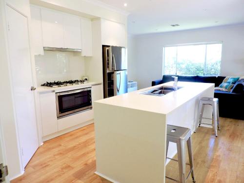 a kitchen with a white counter top in a room at Contemporary Cove - Quindalup in Quindalup