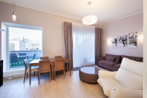 a living room with a couch and a table at MyApartments in Tallinn