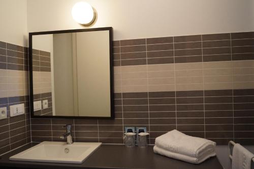 a bathroom with a sink and a mirror at Hotel du Golf de Clécy in Clécy