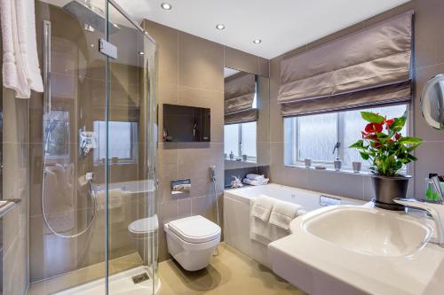 un bagno con lavandino, WC e vasca di Hyde Park Residence a Londra