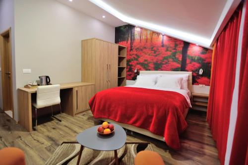 a bedroom with a bed with a red blanket at Villa Cardak in Mostar