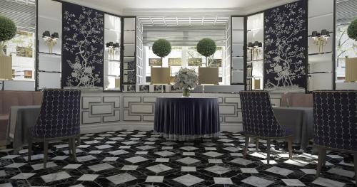a lobby with two chairs and a table with flowers at Relais & Châteaux Heritage Hotel in Madrid