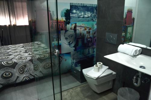 a bathroom with a shower and a toilet and a sink at Bed&Breakfast 10 GIRONA in Girona