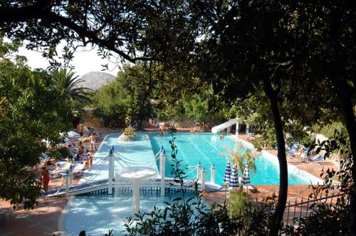 a large swimming pool with a slide in a resort at Agriturismo Antico Casale Colli Di San Pietro in Piano di Sorrento