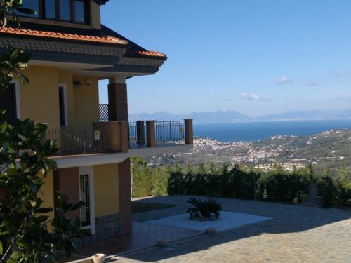 a house with a balcony and a view of the ocean at Casa Vacanza Villa Aurora in Laureana Cilento