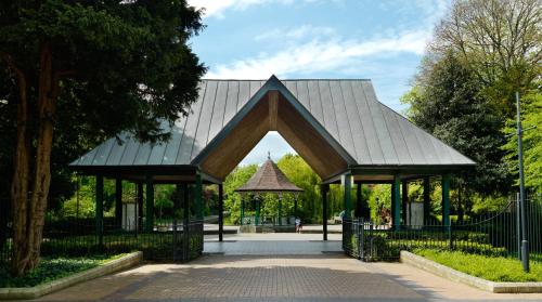 a pavilion with a metal roof in a park at Herbert Park Hotel and Park Residence in Dublin