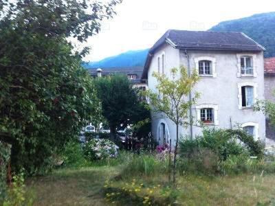 a large white house in the middle of a yard at Apartment Coecilia in Ax-les-Thermes