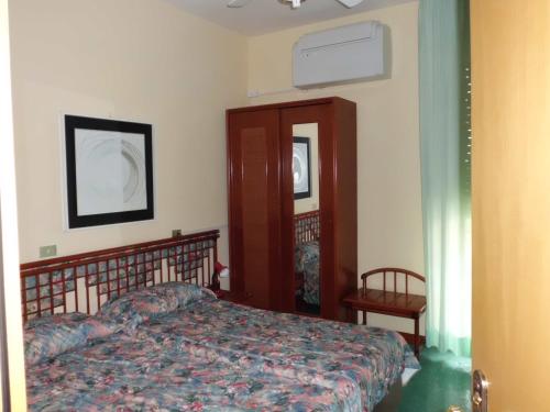 a bedroom with a bed and a dresser in it at Hotel 5 Terre in Monterosso al Mare