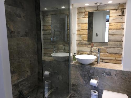 a bathroom with two sinks and a glass shower at Leila in Stratford-upon-Avon