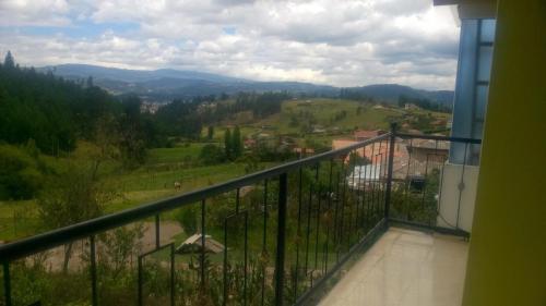 a balcony with a view of a valley at Cabaña Los Hayuelos in Paipa