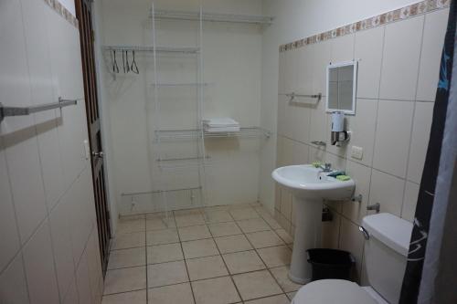 a bathroom with a sink and a toilet and a shower at Villa Vilar in Coco