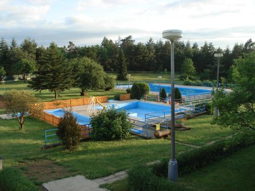 a large swimming pool in a park at Apartmány nad Otavou in Zvíkovské Podhradí