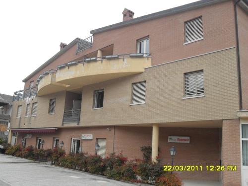 a brick building with a balcony on the side of it at residence la collinetta in Cagli