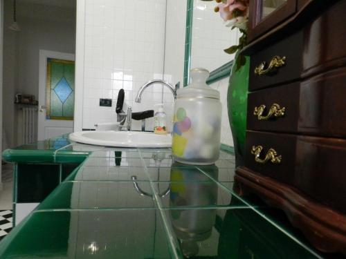 a bathroom with a sink and a glass counter top at Annunziatella95 in Matera