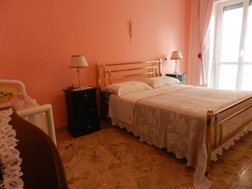 a bedroom with a large bed and a window at Annunziatella95 in Matera