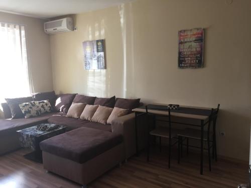 a living room with a couch and a table at Pirotska Apartment GN / FREE GARAGE in Sofia