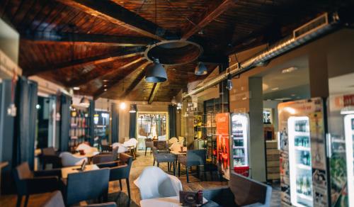 a restaurant with chairs and tables and a ceiling at Boutique Hotel Barrel in Sesvete
