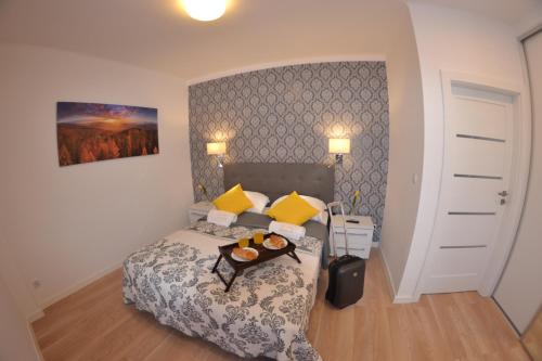 クリニツァ・ズドルイにあるApartament City Center Platinum - Luxury Standardのベッドルーム1室(ベッド1台、食料品のトレイ付)